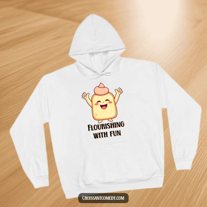 Funny Laughing Pastry Hoodie: A laughing pastry character with raised arms strikes a joyous pose, offering cozy humor.